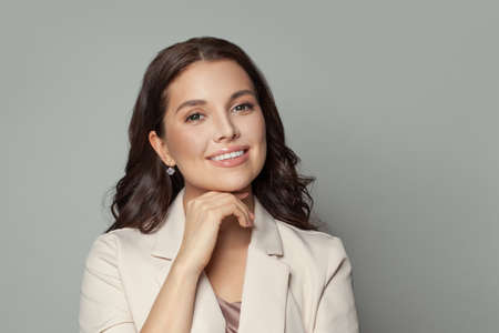 Successful woman smiling on gray banner background portraitの写真素材