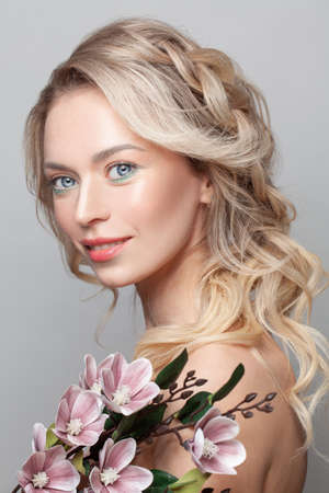 Portrait of gorgeous young woman. Beautiful model with flowers. Cosmetology and beauty spa. Woman...