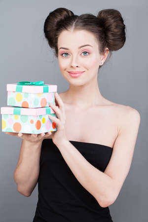 Nice attractive lovely gorgeous excited cheerful woman enjoying present box gift on gray backgroundの写真素材