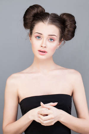 Young beautiful model woman with fashion makeup on bright pink backgroundの写真素材