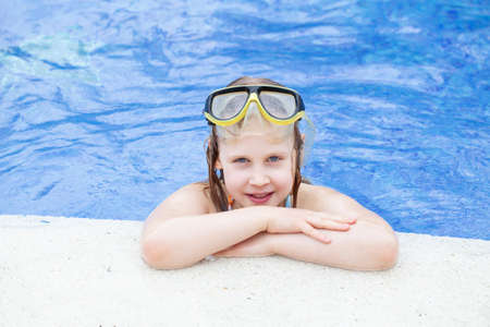 Smiling cute little child girl in poolの写真素材