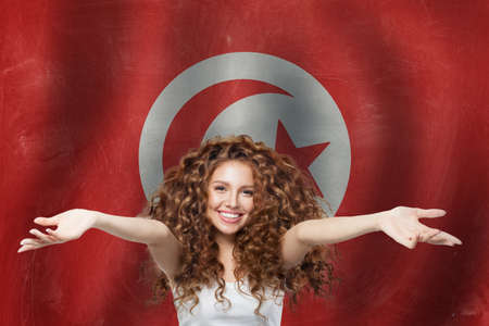 Happy young woman on Tunisia flag background. Travel in Tunisiaの写真素材