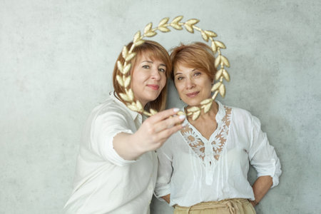 Two mature women looking at camera and smilingの写真素材