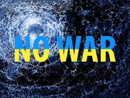 No war concept. Ukrainian flag colors on brocken glass with bullet hole. Stop war in Ukraine conceptの写真素材