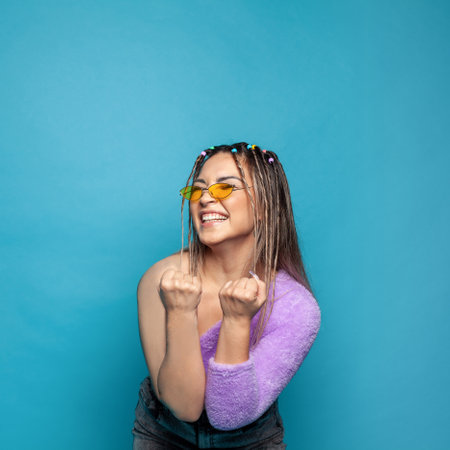 Young woman laughing. Happy gesturing smiling youngfemale model on blueの写真素材