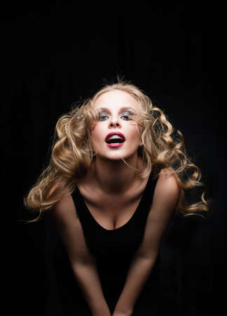 Pretty glamorous blonde fashion model woman with wind in the hair portraitの写真素材