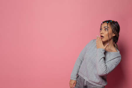 Perfect pretty casual surprised woman with opened mouth on vivid pink studio wall banner background