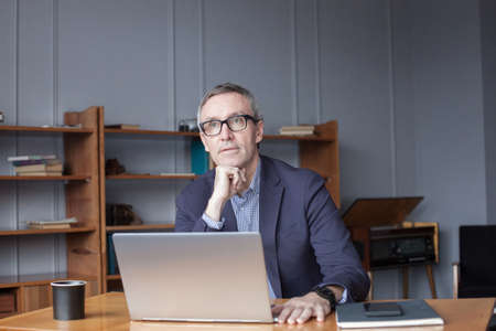 Mature man working on laptop in office