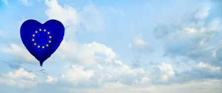 European Union flag on balloon against sky clouds background. Education, charity, emigration, travel and learning in EU conceptの写真素材