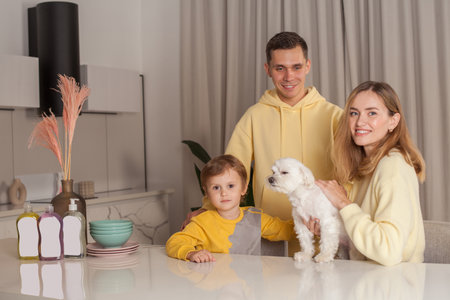 Family, mother and father with child son and white dog, three abstract plastic bottles on the white tableの写真素材