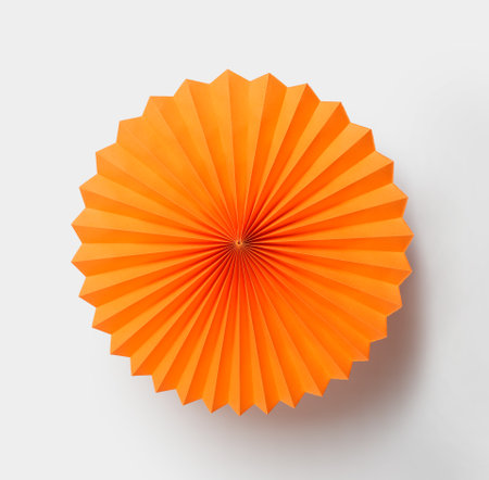 Orange paper fan isolated on white background