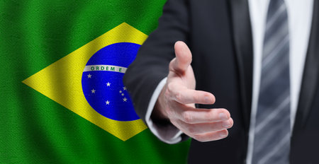 Welcome to the Brazil. Hand on Brazilian flag background. Business, politics, cooperation and travel conceptの写真素材
