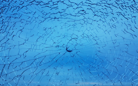 Abstract industrial blue broken glass with a lots of white cracks shot window