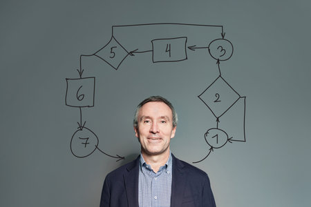 Smiling man with arrows and box, business or education strategy, thinking concept