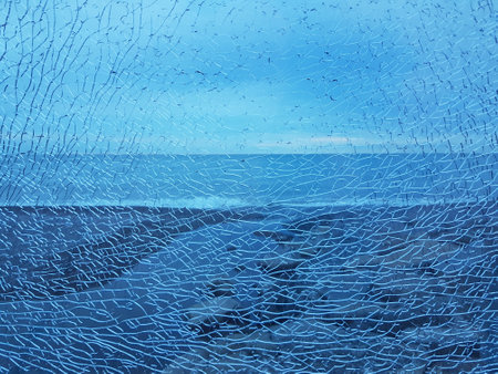 Abstract blue broken glass with a lot of cracks shot window on ocean sea background