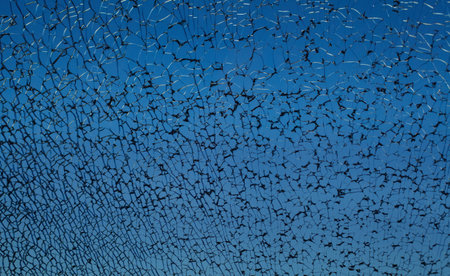 Dark blue broken cracked shattered window glass with black cracks