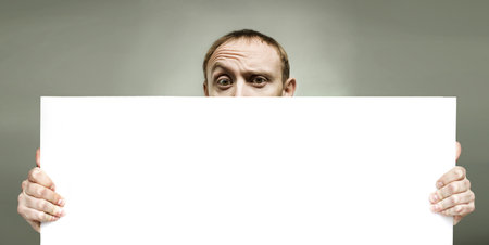 Man holding blank sign paper for advertisingの写真素材