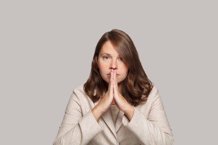 Serious businesswoman against white backgroundの写真素材