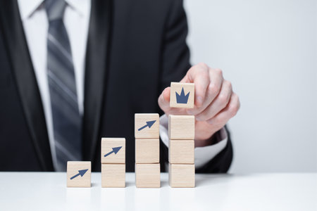 Wooden blocks with black arrows, leadership, carieer business conceptの写真素材