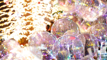 Christmas background with colorful bokeh light, glass ball and defocused Xmas tree with New Year...