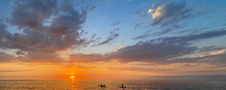 Colorful gold sunset above sea beach. Bright sky with dark cloud. Atmosphere cloudscape skyline...