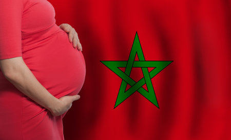 Pregnant woman belly on flag of Morocco backgroundの写真素材