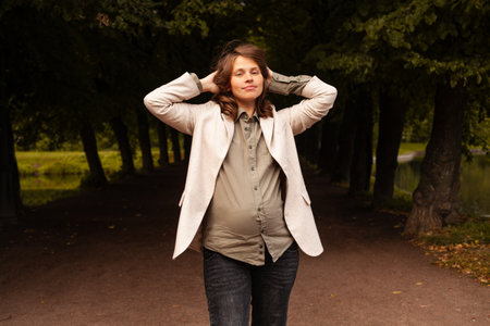 Beautiful pregnant woman relaxing in park outdoorの写真素材