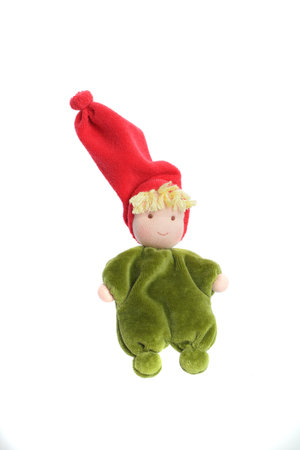 Green plush handmade baby toy in red hat isolated on white background
