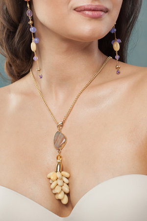 Charming jewelry model. Woman with bijou close up