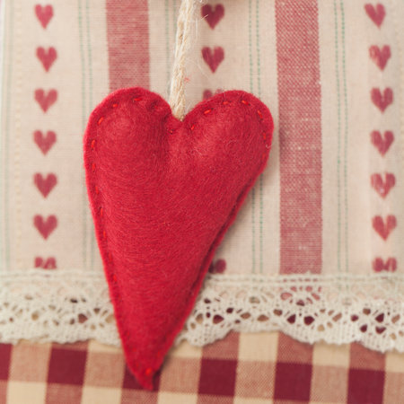 Handmade sewing detail red heart closeupの写真素材