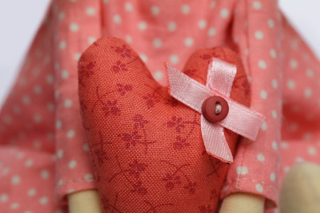 Hand sewing with red fabric and button closeup. Handmade conceptの写真素材