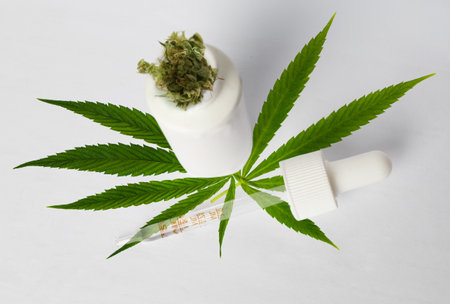 Herbal medicine concept. Medical Marijuana plant and Cannabis oil on white background, top viewの写真素材