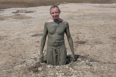 Man in mud geyser resort outdoorの写真素材