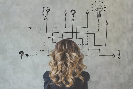 Idea arrows with young businesswoman on gray backgroundの写真素材