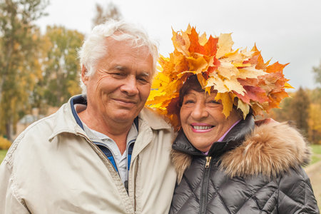 Portrait of happy couple having fun in autumn park