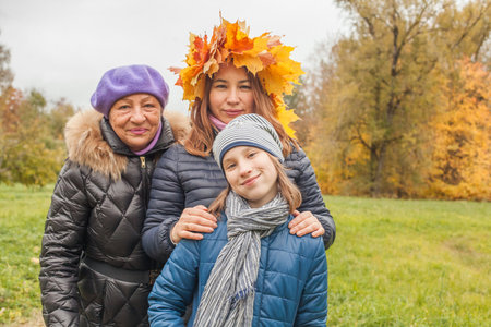 Grandma, mom and daughter portrait. Happy family outdoors, autumn portraitの写真素材