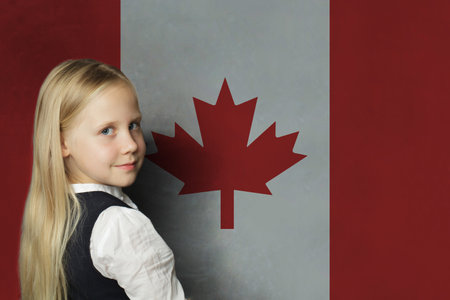 Cute young child girl on Canadian flag background. Education and study language in Canada conceptの写真素材