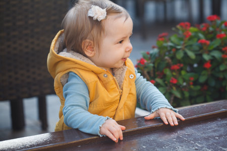 Pretty baby girl 1 year old playing in the yard outdoorsの写真素材