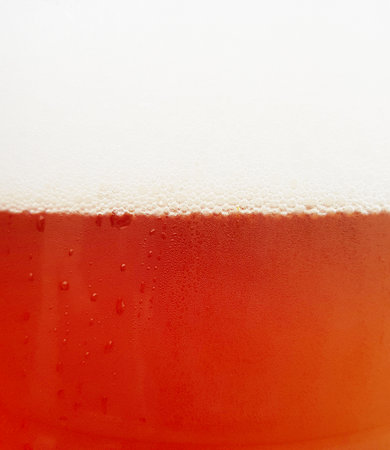 Closeup of beer and foam in glassの写真素材