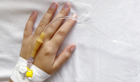 Peripheral Catheter for Multiday Therapy on female hand in hospital, medicine backgroundの写真素材