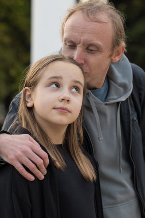 Happy family outdoors portrait. Cute daughter child girl and her father outdoors. Happiness, childhood and bonding conceptの写真素材