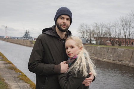 Elegant young woman with blond hair and handsome man outdoors. Happy coupleの写真素材