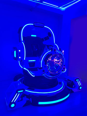 Indoor amusement park with futuristic attractions and neon lighting