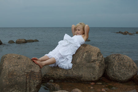 Resting little girl outdoors portraitの写真素材
