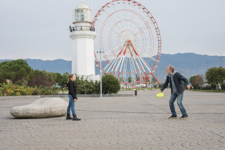 Family together. Father and daughter playing flying disc and having fun outdoors. Happy family, sport and leisure activity conceptの写真素材