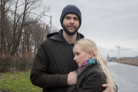 Blonde young woman with blond hair and handsome man outdoors. Happy coupleの写真素材