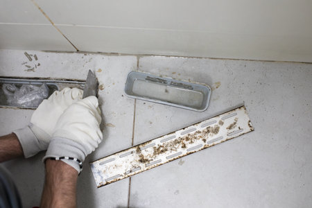 Sewer hole, bathroom drain and worker handsの写真素材