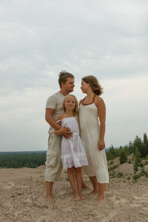 Loving family. Father, mother and daughter outdoorsの写真素材