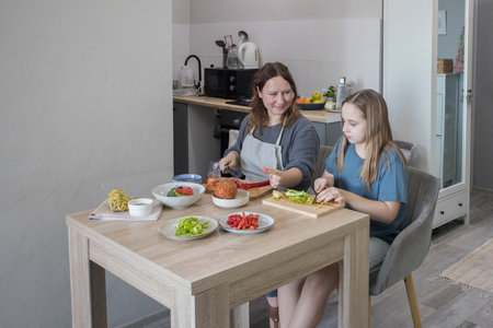 Mother and daughter having fun with the vegetablesの写真素材