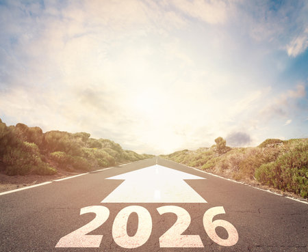 Empty road to 2026 year. Road with written 2026 and arrow pointing towards the horizon, future, new beginning in the New Year 2026 concept.の写真素材